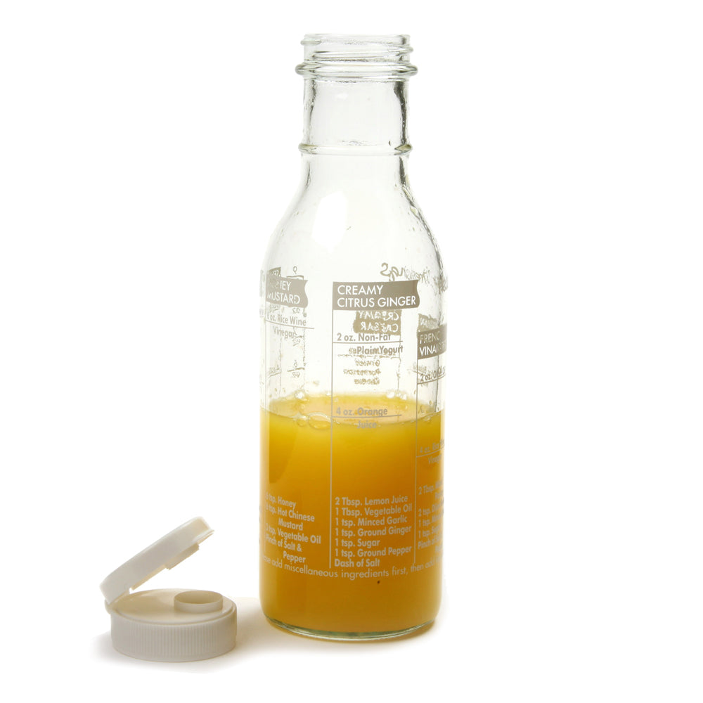 Clear glass bottle with orange liquid and measurement markings on a white background