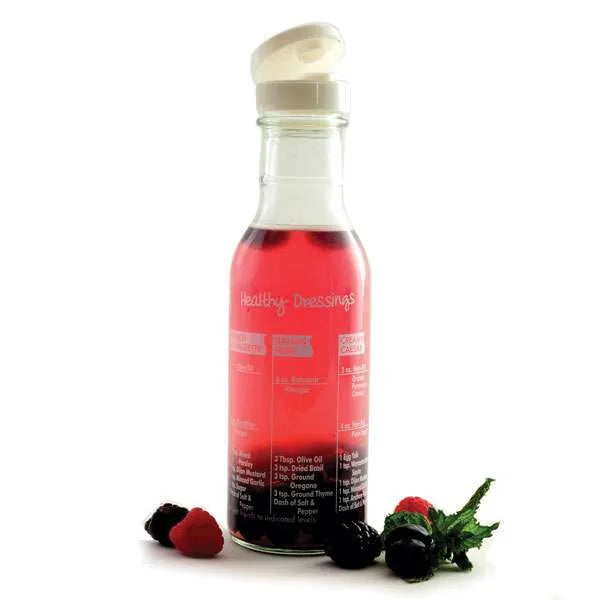 Bottle of salad dressing with a white cap on a white background