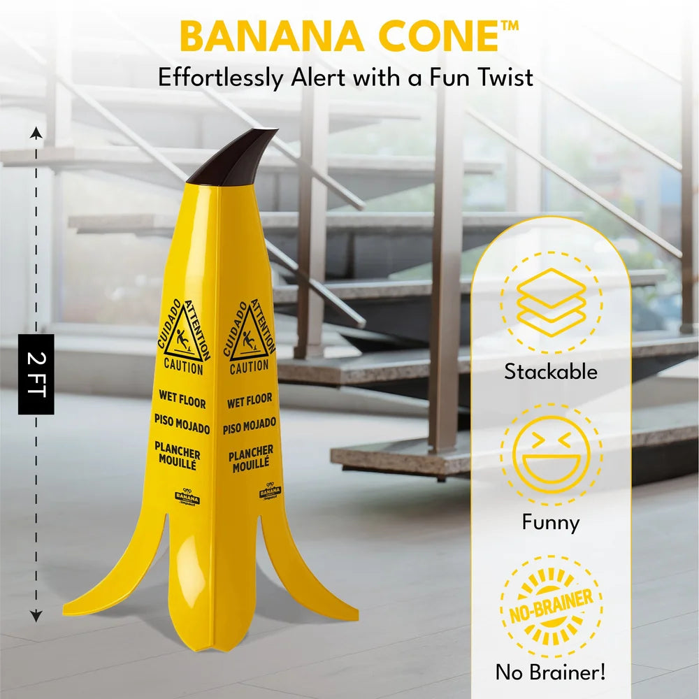 A novelty yellow banana-shaped caution sign standing on a glossy floor, with a blurred office interior in the background. Text at the top reads 'BANANA CONE' and 'Effortlessly Alert with a Fun Twist,' with a side measurement marking 2 FT and a vertical feature callout listing 'Stackable,' 'Funny,' and 'No Brainer!'.